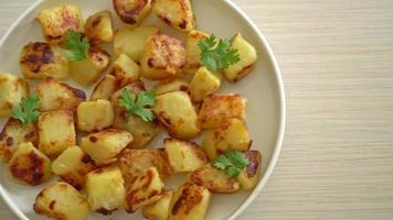 Roasted or grilled potatoes  on white plate