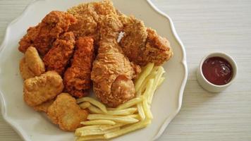 pollo frito con papas fritas y nuggets en el plato - comida poco saludable video