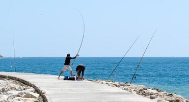 CABO PINO, ANDALUCIA, SPAIN, 2014. Men Sea Fishing photo