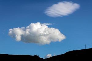 Fluffy cloud passing over Val d'Orcia Tuscany