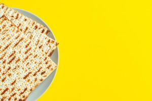 Celebrating the traditional Jewish holiday of Passover. Matzo on a yellow background. Pesach matzah.