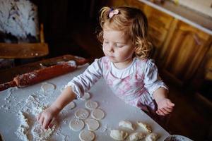 child preparing dough photo