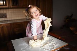 child preparing dough photo