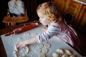 child preparing dough photo