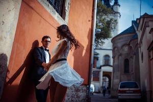 Young couple in love, hugging in the old part of town photo