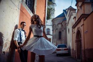Young couple in love, hugging in the old part of town photo