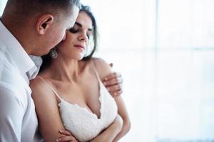 Wedding couple in hotel room photo