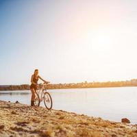 woman on a bicycle in  beach photo