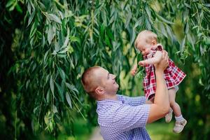 father and daughter. man and beautiful little girl outdoors in park photo