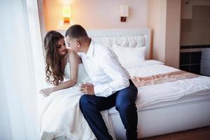 Bride sitting on the bed photo