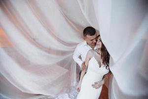 Wedding couple in hotel room photo