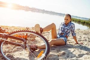 woman on a bicycle in beach photo