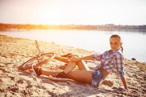 woman on a bicycle in beach photo