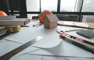 Business objects of architect on desk with engineer tools and architect analyzer working with blueprints and model house,Team meeting concept.Project ideas concept.Vintage effect,selective focus. photo