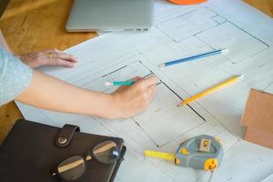 Hands of architect or engineer using drawing compass with blueprint on desk in office.Team of architects engineer discussing and check documents and business workflow.Construction concept. photo