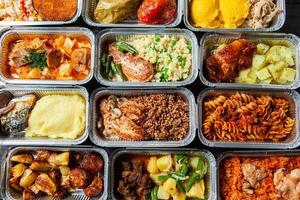 Business lunch in eco plastic container ready for delivery.Top view. Office Lunch boxes with food ready to go. Food takes away. Catering, brakfast. photo