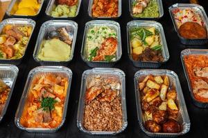 Business lunch in eco plastic container ready for delivery.Top view. Office Lunch boxes with food ready to go. Food takes away. Catering, brakfast. photo