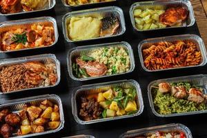 Business lunch in eco plastic container ready for delivery.Top view. Office Lunch boxes with food ready to go. Food takes away. Catering, brakfast. photo