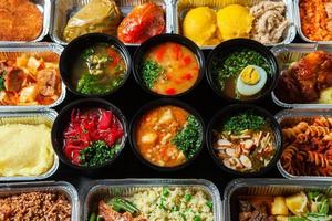 Business lunch in eco plastic container ready for delivery.Top view. Office Lunch boxes with food ready to go. Food takes away. Catering, brakfast. photo