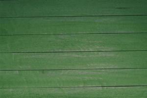 Vintage green wood background texture with knots and nail holes. Old painted wood wall. Brown abstract background. Vintage wooden dark horizontal boards. Front view with copy space photo