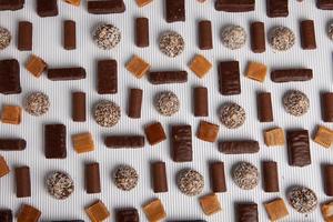 Assortment of delicious chocolate candies background. Chocolate candy isolated. photo