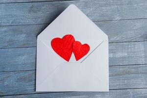 Love hearts on wooden texture background. Valentines day card concept. Heart for Valentines Day Background. photo