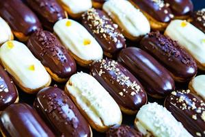 Traditional french eclairs with chocolate. Tasty dessert. Home made cake eclairs. Sweet Dessert Pastry filled with cream. Chocolate icing. photo
