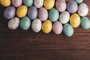 Hand painted pastel colored Easter eggs background. Happy Easter greeting card or invitation. photo