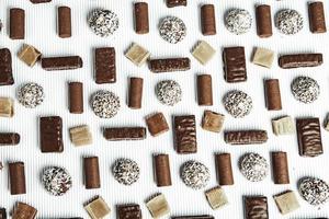 Assortment of delicious chocolate candies background. Chocolate candy isolated. photo