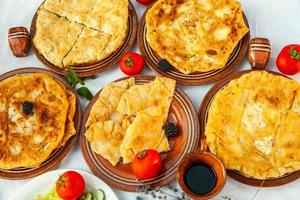 Traditional fried pies from Romania with potatoes, cheese and cabbage. Romanian food. photo