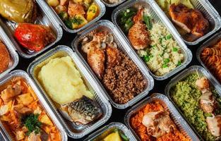 Business lunch in eco plastic container ready for delivery.Top view. Office Lunch boxes with food ready to go. Food takes away. Catering, brakfast. photo
