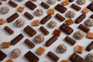 Assortment of delicious chocolate candies background. Chocolate candy isolated. photo