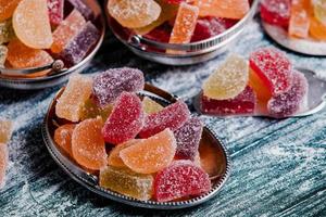 Collection of colorful marmalade candles. Sweet table with Bonbon Jars. photo