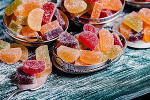 Collection of colorful marmalade candles. Sweet table with Bonbon Jars. photo