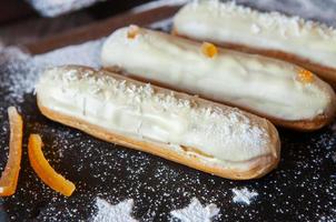 Traditional french eclairs with chocolate. Tasty dessert. Home made cake eclairs. Sweet Dessert Pastry filled with cream. Chocolate icing. photo