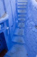 Blue street and houses in Chefchaouen, Morocco. Beautiful colored medieval street painted in soft blue color. photo