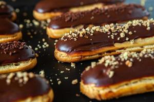 Traditional french eclairs with chocolate. Tasty dessert. Home made cake eclairs. Sweet Dessert Pastry filled with cream. Chocolate icing. photo