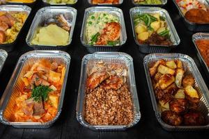 Business lunch in eco plastic container ready for delivery.Top view. Office Lunch boxes with food ready to go. Food takes away. Catering, brakfast. photo