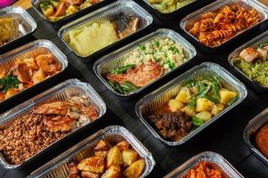 Business lunch in eco plastic container ready for delivery.Top view. Office Lunch boxes with food ready to go. Food takes away. Catering, brakfast. photo