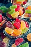 Collection of colorful marmalade candles. Sweet table with Bonbon Jars. photo