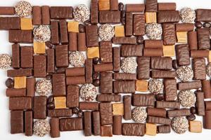 Assortment of delicious chocolate candies background. Chocolate candy isolated. photo