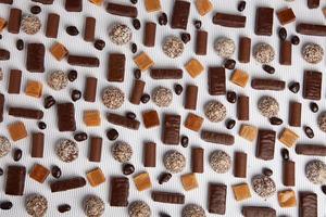 Assortment of delicious chocolate candies background. Chocolate candy isolated. photo