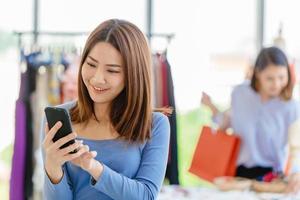 Smart customer using mobile phone to finding promotion search sale item and payment in shopping store photo