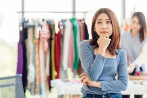 clothing shop owner thinking worry about financial problem business money income and profit photo