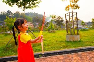 Lovely Baby girl wears yellow-orange outfit, gokowa outfit or Mugunghwa playing bubble in a public park. Girls and teen fashion dress. photo