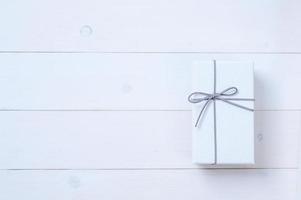 An empty cardboard box with a leather bow that is used for keeping gifts brought together on a festive day photo