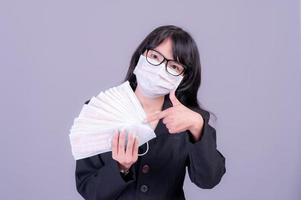 Asian business women have to use a mask to cover the face to prevent pollution from dust photo