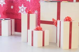 Christmas boxes on a crimson decorated background.Gifts for Holiday.Christmas and new year concept.