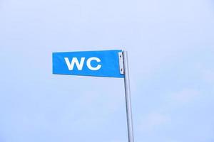 WC sign against sky photo