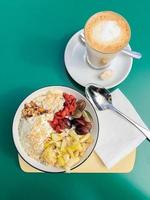 healthy breakfast bowl with fresh fruit and flat white coffee photo